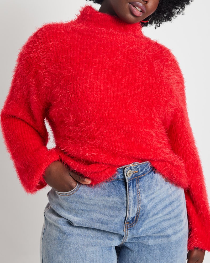 Front of a model wearing a size 14/16 Viv Mock Neck Faux Fur Sweater in High Risk Red by ELOQUII. | dia_product_style_image_id:236352